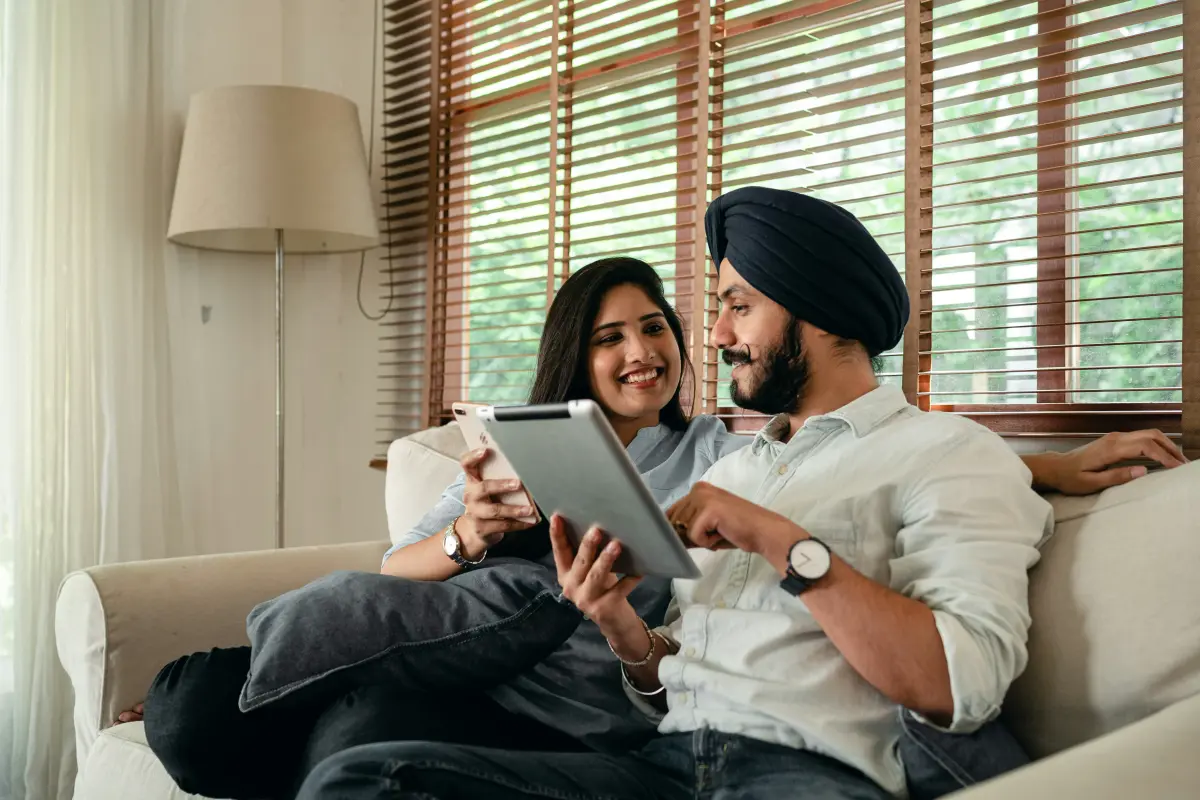 Couple managing smart home with tablet
